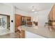 Kitchen featuring a bar with granite counter and stainless steel fridge at 1831 Stable Trl, Palm Harbor, FL 34685