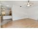 Spacious living area blending a kitchen, dining, and sitting area with sleek wood-look flooring at 1831 Stable Trl, Palm Harbor, FL 34685