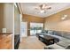 Cozy living room with plush sectional, dark wood coffee table, and sliding glass doors to pool at 1831 Stable Trl, Palm Harbor, FL 34685
