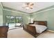 Main bedroom has a ceiling fan and view of the pool at 1831 Stable Trl, Palm Harbor, FL 34685