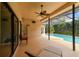 Inviting pool patio featuring lounge seating, ceiling fan, and screened enclosure at 1831 Stable Trl, Palm Harbor, FL 34685