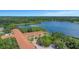 An amazing aerial view showcases the condo near a lake and wooded surroundings at 2021 Shangrila Dr # 14, Clearwater, FL 33763