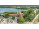 Aerial view of condo complex surrounded by mature trees and scenic lake at 2021 Shangrila Dr # 14, Clearwater, FL 33763