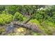 Aerial view of a wooden walkway, surrounded by lush greenery and a pond at 2021 Shangrila Dr # 14, Clearwater, FL 33763
