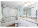 Bathroom featuring white vanity with granite countertop, a shower-tub, and nautical decor at 2021 Shangrila Dr # 14, Clearwater, FL 33763