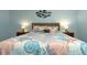 Bedroom with a decorative headboard, starfish decor, and two night stands with lamps at 2021 Shangrila Dr # 14, Clearwater, FL 33763