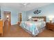 Spacious bedroom with wood flooring, en-suite bath, and coastal themed decorations at 2021 Shangrila Dr # 14, Clearwater, FL 33763
