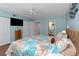 Coastal themed bedroom with closet, tv, decorative headboard, and access to an en-suite bath at 2021 Shangrila Dr # 14, Clearwater, FL 33763