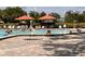 Resort-style community pool with lounge chairs and umbrellas, great for relaxation at 2021 Shangrila Dr # 14, Clearwater, FL 33763