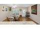Dining area with a round table, seating for four, and ample natural light from the window with shutters at 2021 Shangrila Dr # 14, Clearwater, FL 33763
