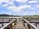 Wooden dock with lake views, perfect for enjoying nature and the outdoors at 2021 Shangrila Dr # 14, Clearwater, FL 33763