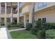 Exterior view of condo complex with manicured landscaping and access ramp at 2021 Shangrila Dr # 14, Clearwater, FL 33763