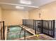 Indoor hot tub with tile surround and safety fencing; a perfect relaxation spot at 2021 Shangrila Dr # 14, Clearwater, FL 33763
