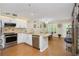 Stylish kitchen featuring white cabinets, granite countertops, stainless steel appliances, and a dining nook at 2021 Shangrila Dr # 14, Clearwater, FL 33763