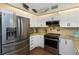 Updated kitchen features stainless steel appliances and bright white cabinetry at 2021 Shangrila Dr # 14, Clearwater, FL 33763