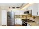 Bright kitchen features stainless steel appliances, granite counters, and white cabinetry at 2021 Shangrila Dr # 14, Clearwater, FL 33763