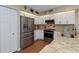 Well-appointed kitchen showcasing stainless steel appliances, granite countertops, and ample cabinet space at 2021 Shangrila Dr # 14, Clearwater, FL 33763