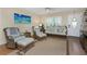 Relaxing living room with shuttered windows, comfortable wicker furniture, and coastal-themed decor at 2021 Shangrila Dr # 14, Clearwater, FL 33763
