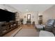 Inviting living room with hardwood floors, a large TV, and comfortable seating with a view of a hallway at 2021 Shangrila Dr # 14, Clearwater, FL 33763