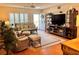 Inviting living room featuring a ceiling fan, natural light, and tropical-themed furnishings for a relaxed atmosphere at 2021 Shangrila Dr # 14, Clearwater, FL 33763