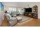 Comfortable living room showcasing hardwood floors, shuttered windows, and tasteful decor with comfortable seating at 2021 Shangrila Dr # 14, Clearwater, FL 33763