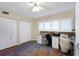 Well-lit home office with custom desk, storage, and plantation shutters for a serene work environment at 2021 Shangrila Dr # 14, Clearwater, FL 33763