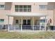 View of a cozy, covered patio with comfortable seating and a well-maintained lawn at 2021 Shangrila Dr # 14, Clearwater, FL 33763