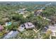 An aerial view of a charming house with mature trees, pool, and lovely neighborhood at 2710 N Dundee St, Tampa, FL 33629