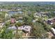 An aerial view of a charming house with mature trees, pool, and lovely neighborhood at 2710 N Dundee St, Tampa, FL 33629