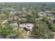 An aerial view of a charming house with mature trees, pool, and lovely neighborhood at 2710 N Dundee St, Tampa, FL 33629