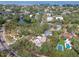 An aerial view of a charming house with mature trees and a beautifully landscaped lot at 2710 N Dundee St, Tampa, FL 33629