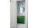 A modern bathroom with a pop of color featuring a vibrant green vanity and stylish fixtures at 2710 N Dundee St, Tampa, FL 33629