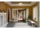 A stylish entryway featuring tiled floors, high ceilings, and a view of a sunroom with a swing at 2710 N Dundee St, Tampa, FL 33629
