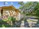 Side exterior showcasing a brick house with surrounding foliage and mature trees at 2710 N Dundee St, Tampa, FL 33629