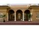 Inviting front porch with brick flooring, white pillars, and hanging plants at 2710 N Dundee St, Tampa, FL 33629