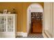 Inviting hallway with views of a bookcase-lined study and detailed floors with a patterned rug at 2710 N Dundee St, Tampa, FL 33629