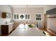 Bright kitchen with a large island, modern countertops, and wooden cabinets with lots of sunlight from the windows at 2710 N Dundee St, Tampa, FL 33629