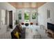 Cozy living room with stylish tile floors, a modern sofa, and a view of the outdoor garden through arched windows at 2710 N Dundee St, Tampa, FL 33629