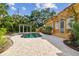 Backyard pool area with brick pavers and a charming pergola feature at 2710 N Dundee St, Tampa, FL 33629