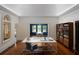 Bright study features hardwood floors, a wall of bookshelves, and a unique arched window at 2710 N Dundee St, Tampa, FL 33629