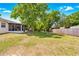 Expansive backyard with a well-maintained lawn, fire pit, and mature trees at 27343 Warner Ave, Brooksville, FL 34602