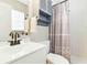 Cozy bathroom with a shower, tiled walls and floors, and decorative shower curtain at 27343 Warner Ave, Brooksville, FL 34602