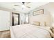 Bright bedroom features a large bed, ceiling fan, modern decor, and wood-look floors at 27343 Warner Ave, Brooksville, FL 34602