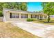 Charming single-story home featuring a classic brick facade and well-maintained landscaping at 27343 Warner Ave, Brooksville, FL 34602