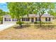 Inviting single-story home with manicured landscaping and classic curb appeal at 27343 Warner Ave, Brooksville, FL 34602