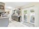 Well-lit kitchen with grey cabinetry, tile floors, and outdoor access at 27343 Warner Ave, Brooksville, FL 34602