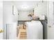 This is the laundry room with a washer, shelving, decor and a folding table at 27343 Warner Ave, Brooksville, FL 34602