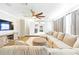 Spacious living area with a large sectional, TV, and ceiling fan at 27343 Warner Ave, Brooksville, FL 34602