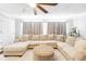 Bright living room with a large sectional, ottoman, and neutral decor at 27343 Warner Ave, Brooksville, FL 34602