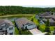Scenic aerial view of a home with a pool, lake, and lush landscaping, offering a serene and private setting at 2826 Riders Pass, Odessa, FL 33556